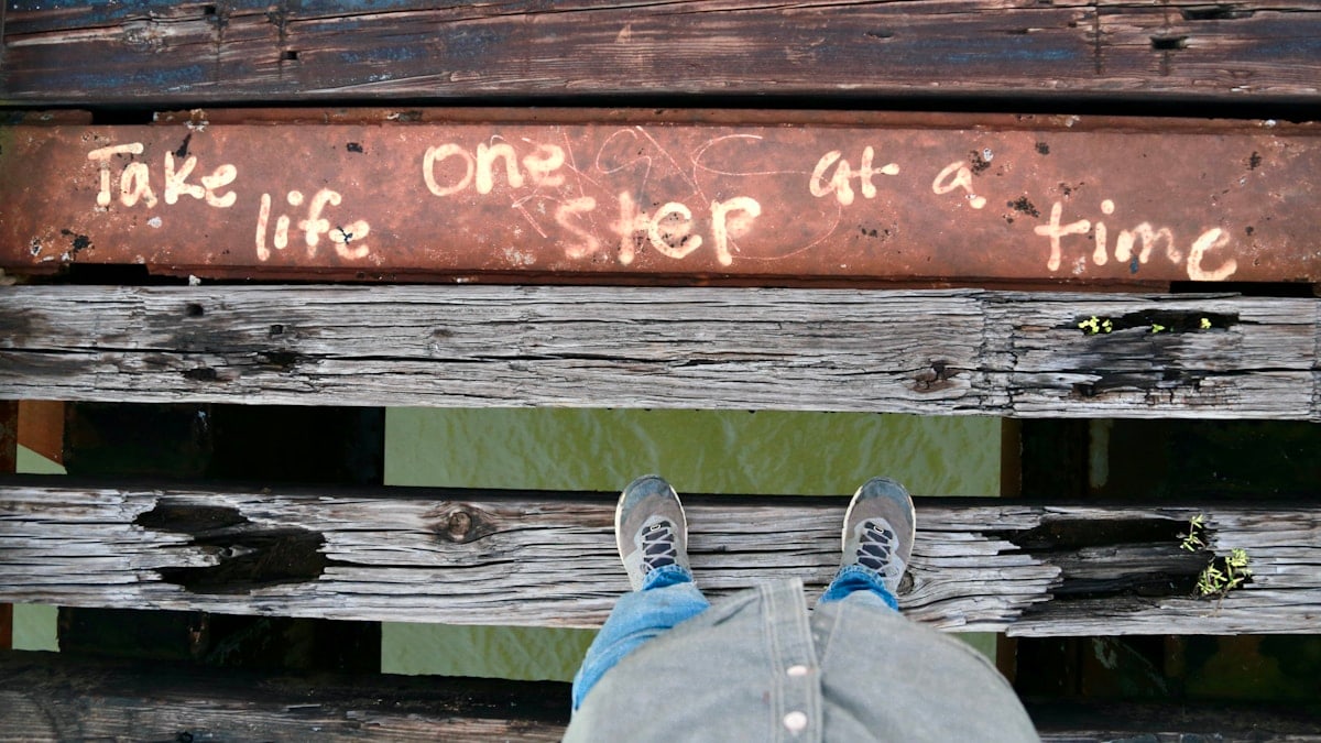 a person with their feet up on a bench